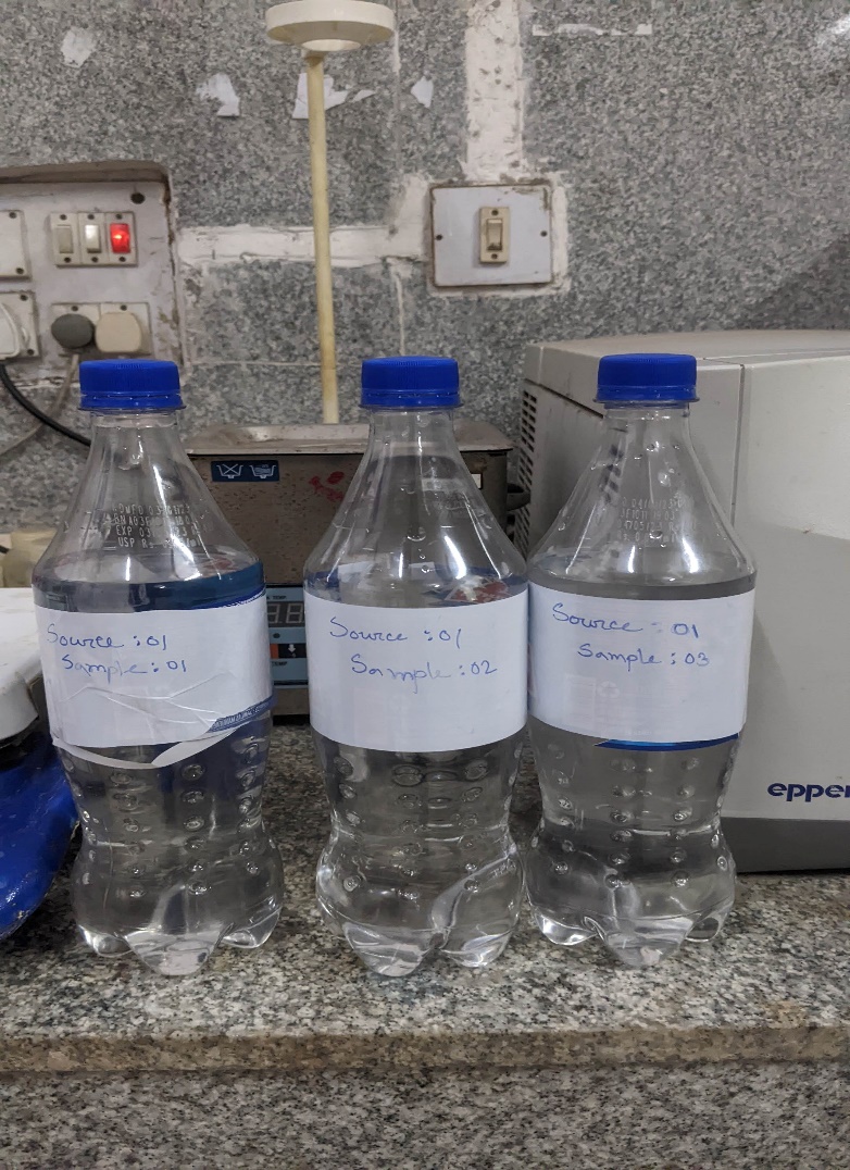 A group of bottles on a counter Description automatically generated with low confidence